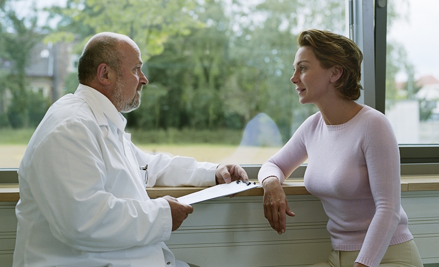 doctor talking with patient at window