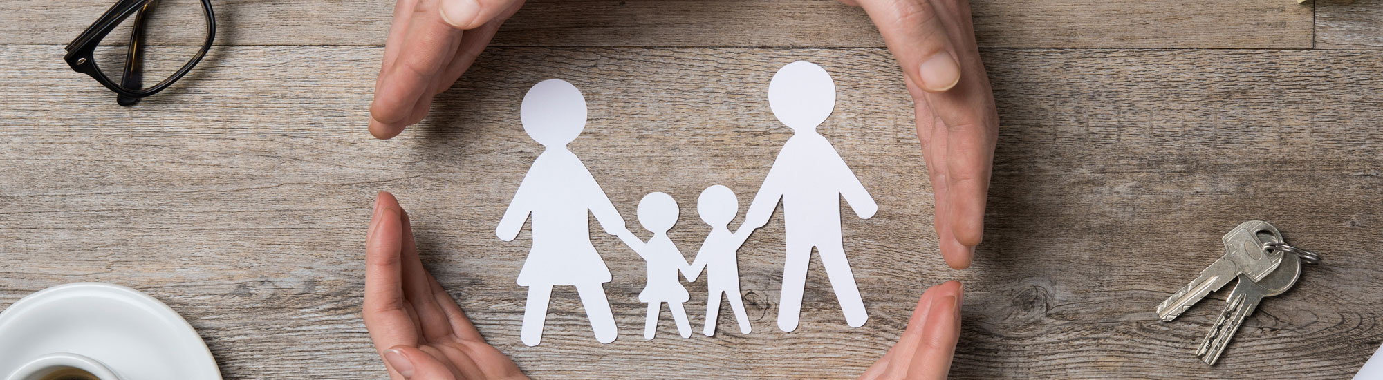 Paper cut-out of family on a desk