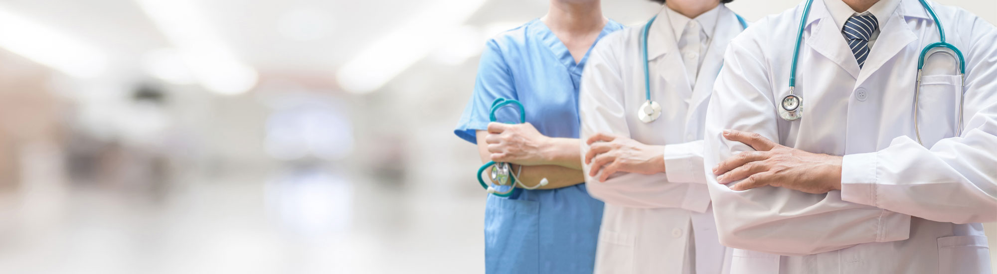 Three medical providers standing with arms folded Three medical providers standing with arms folded