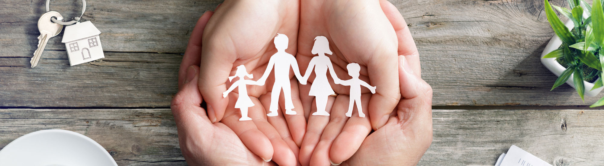 Paper cut-out of family on a desk